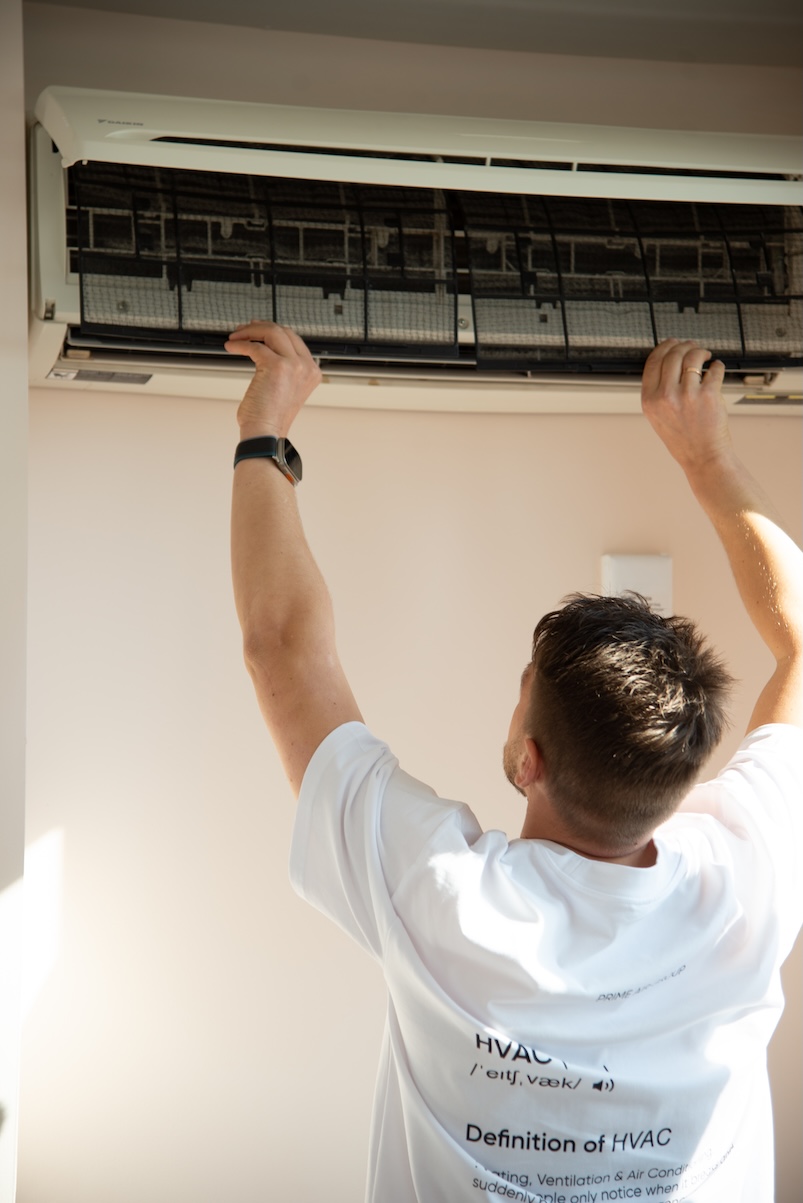 Technician servicing a wall-mounted mini-split