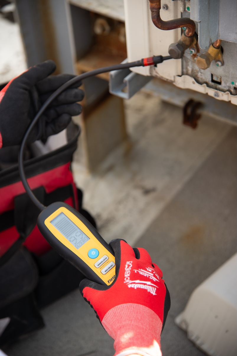 Technician performing HVAC diagnostics and repair
