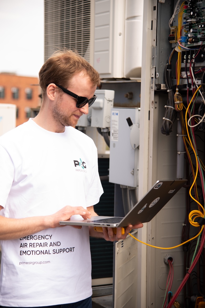 Technician diagnosing HVAC equipment on site
